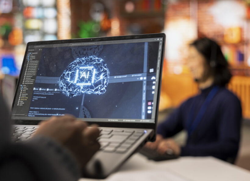 Call center worker using AI tech on laptop to reply to customers, closeup Artificial intelligence transforming enterprise application development for smarter, data-driven business outcomes