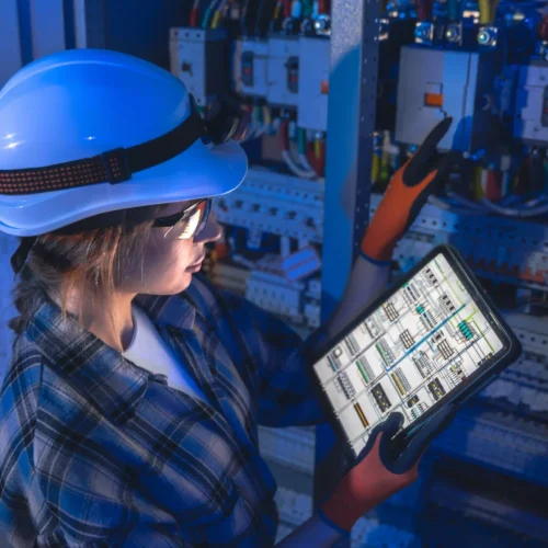 female-electrician-runs-switchboard-check-with-tablet-data-connected-service